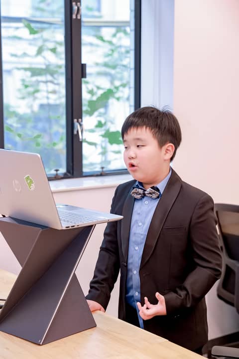 boy reading aloud for his debate