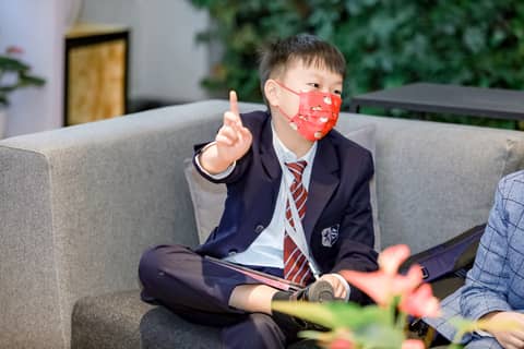 masked boy talking
