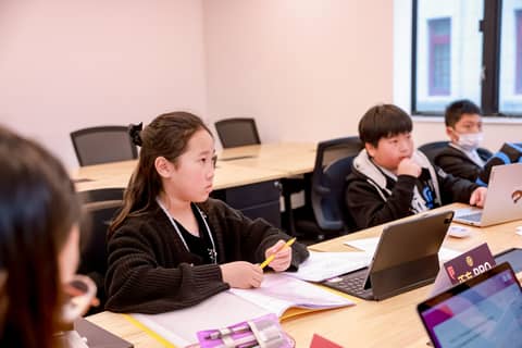 girl and boy at a desk preparing their debate